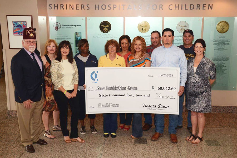 Calpine employee volunteers presented part of the proceeds from the 2014 golf tournament to Shriners Hospital for Children – Galveston.